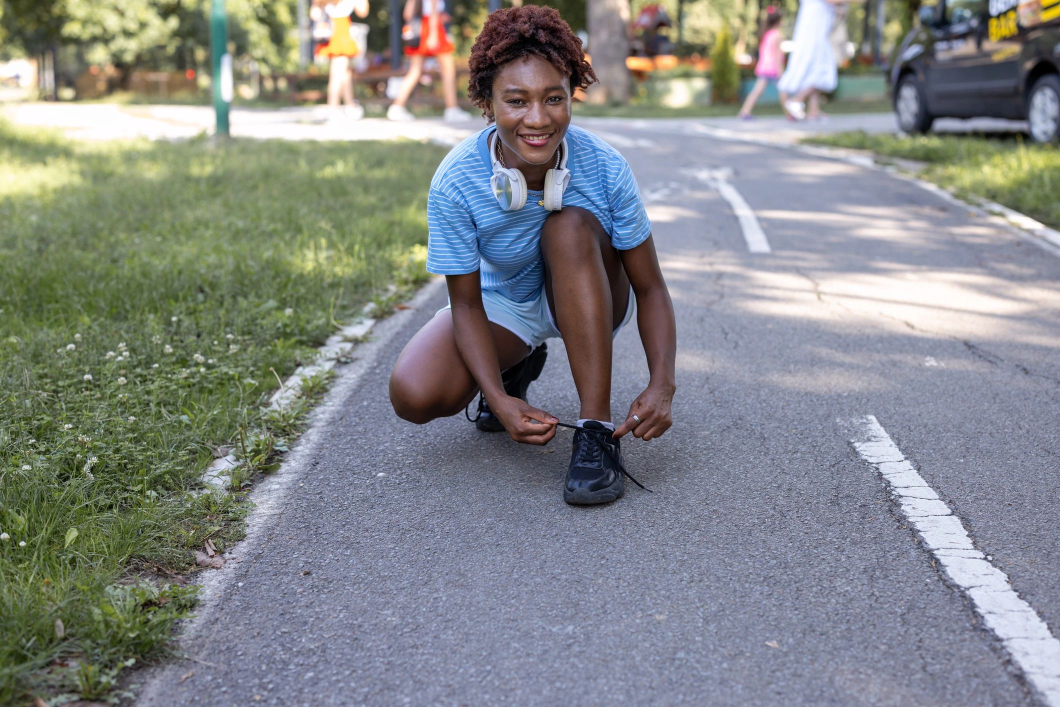 Team member headshot-style image of athlete tying shoes