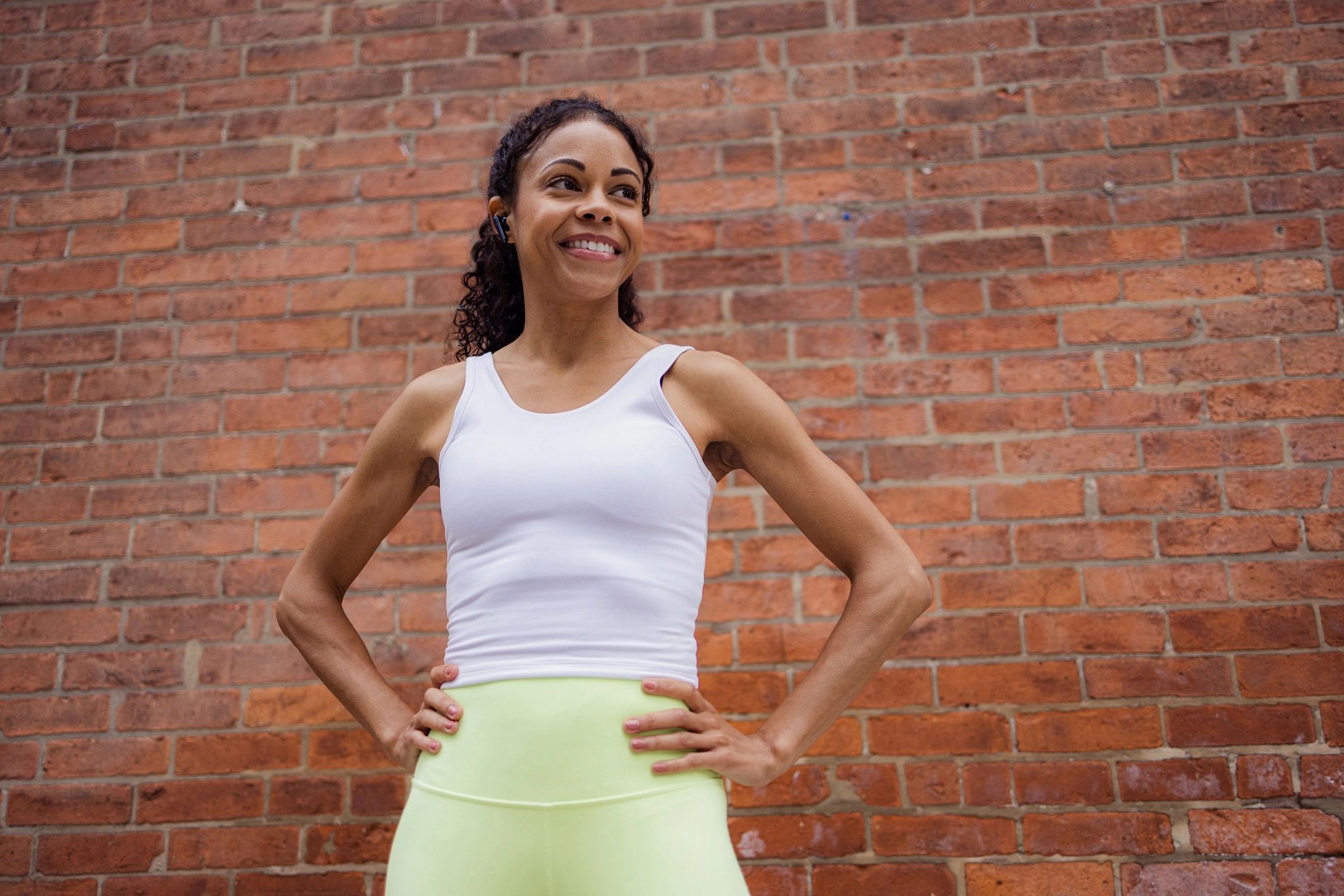 Customer in activewear smiling outdoors