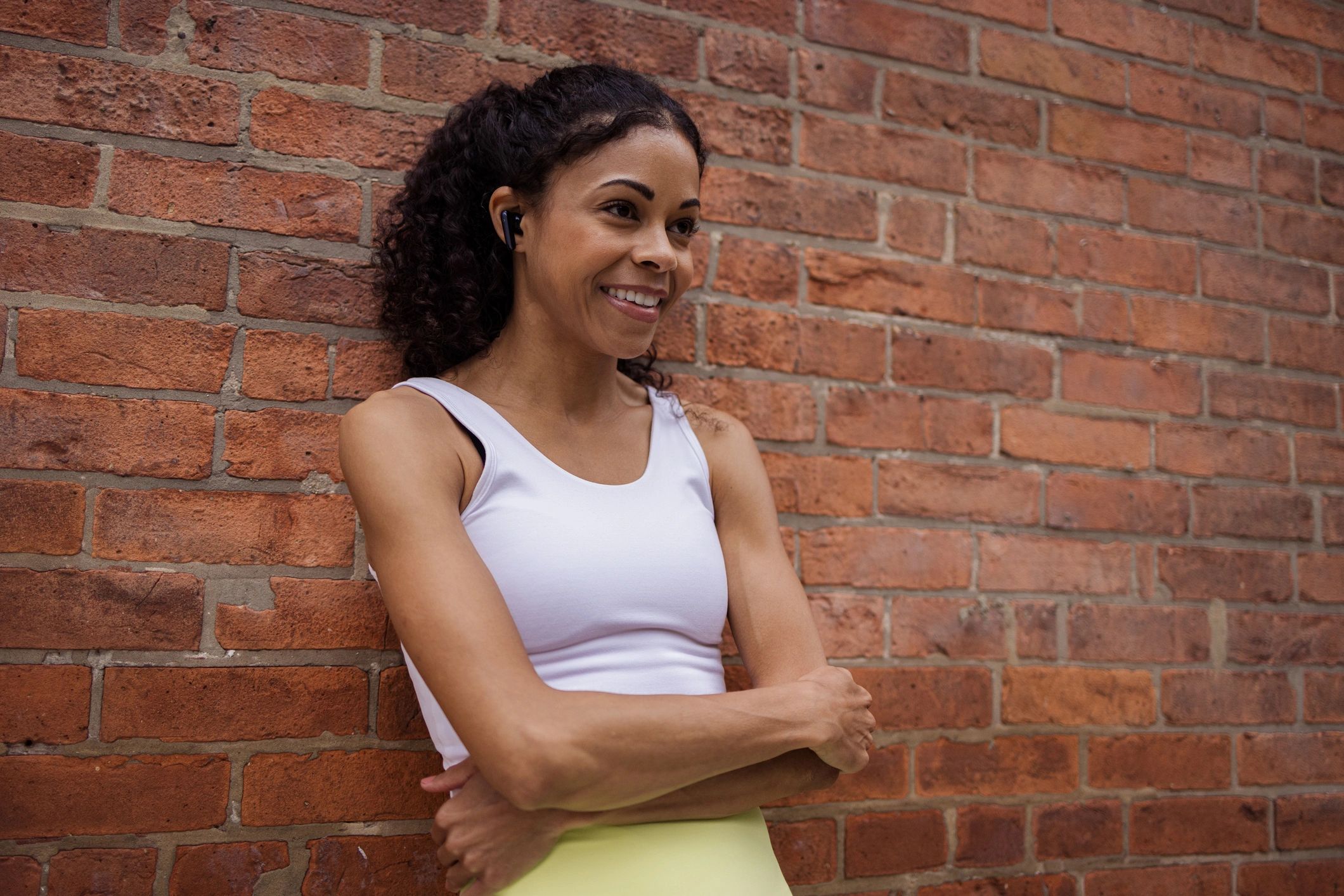 Team member headshot-style image of athlete smiling with arms crossed